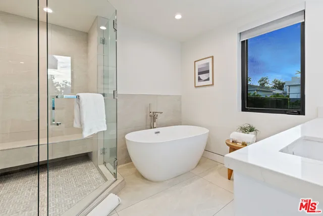 a bedroom with a large bed and a balcony