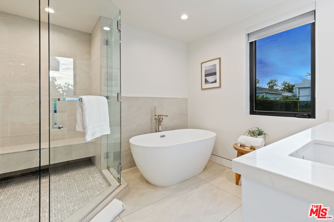 731 North Curson Avenue Los Angeles, CA 90046 - Photo 33 of 75 a bathroom with a bathtub and mirror