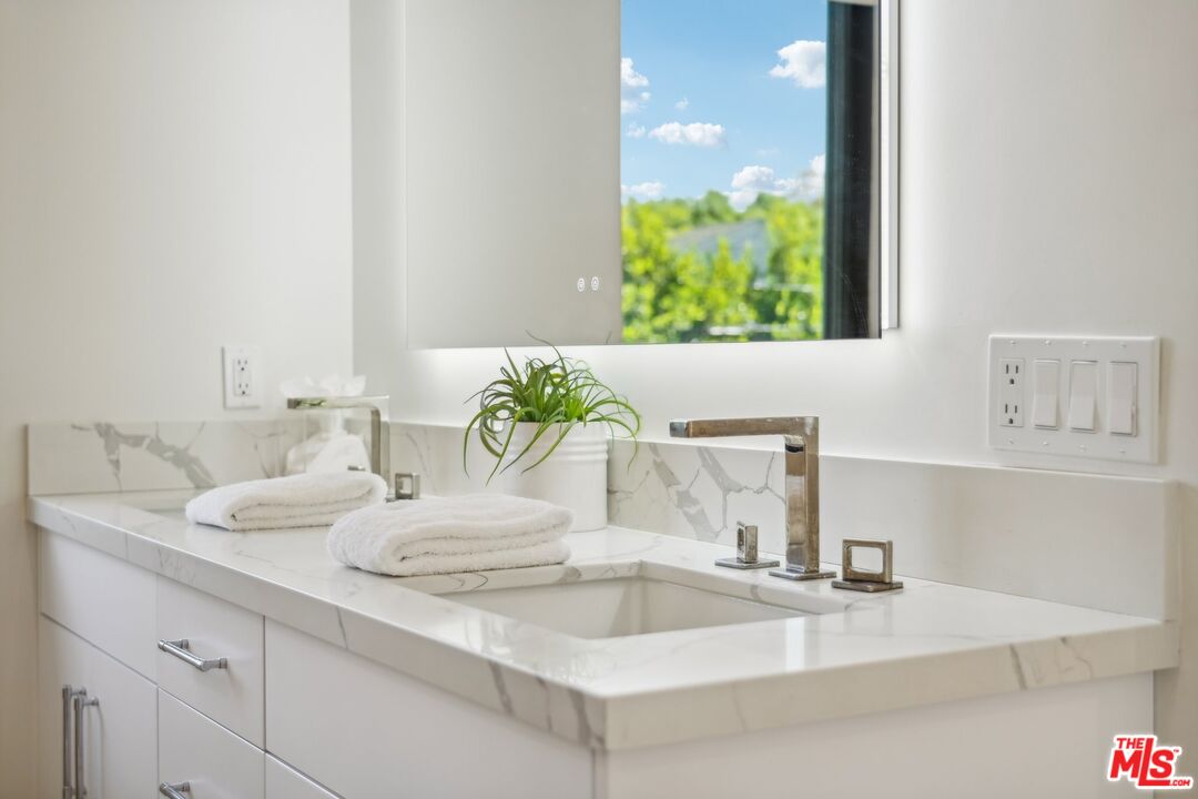 731 North Curson Avenue Los Angeles, CA 90046 - Photo 35 of 75 a bathroom with a sink and a mirror
