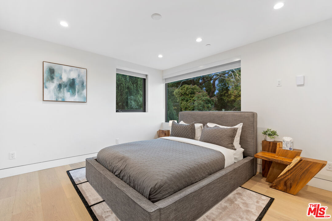 731 North Curson Avenue Los Angeles, CA 90046 - Photo 37 of 75 a bedroom with a large bed and a window