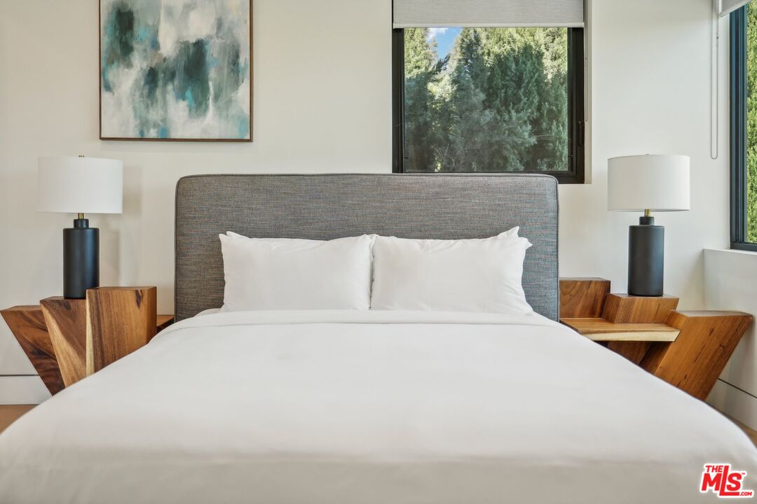 731 North Curson Avenue Los Angeles, CA 90046 - Photo 38 of 75 a large bed sitting in a bedroom next to a window