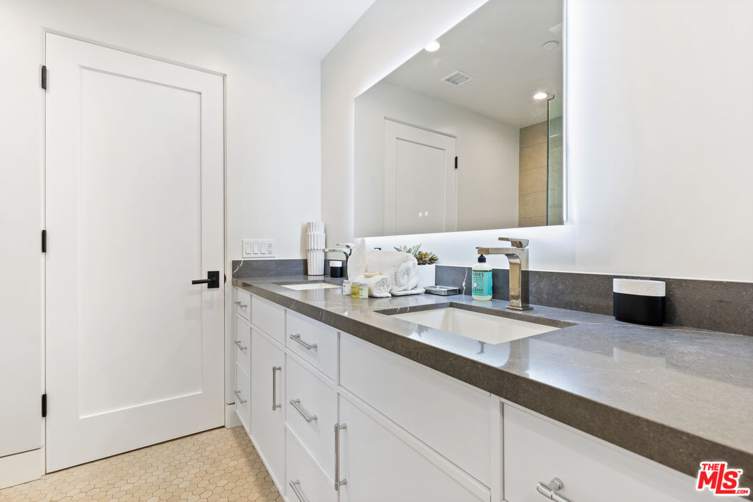 731 North Curson Avenue Los Angeles, CA 90046 - Photo 40 of 75 a bathroom with a double vanity sink and mirror