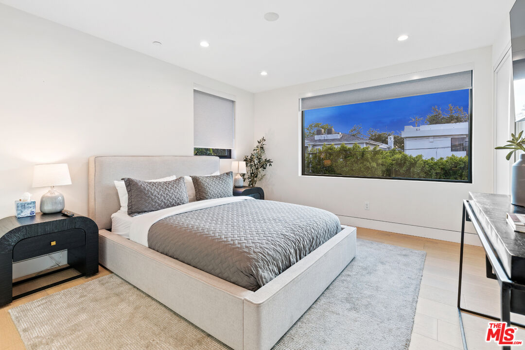 731 North Curson Avenue Los Angeles, CA 90046 - Photo 42 of 75 a living room with a bed and a large window
