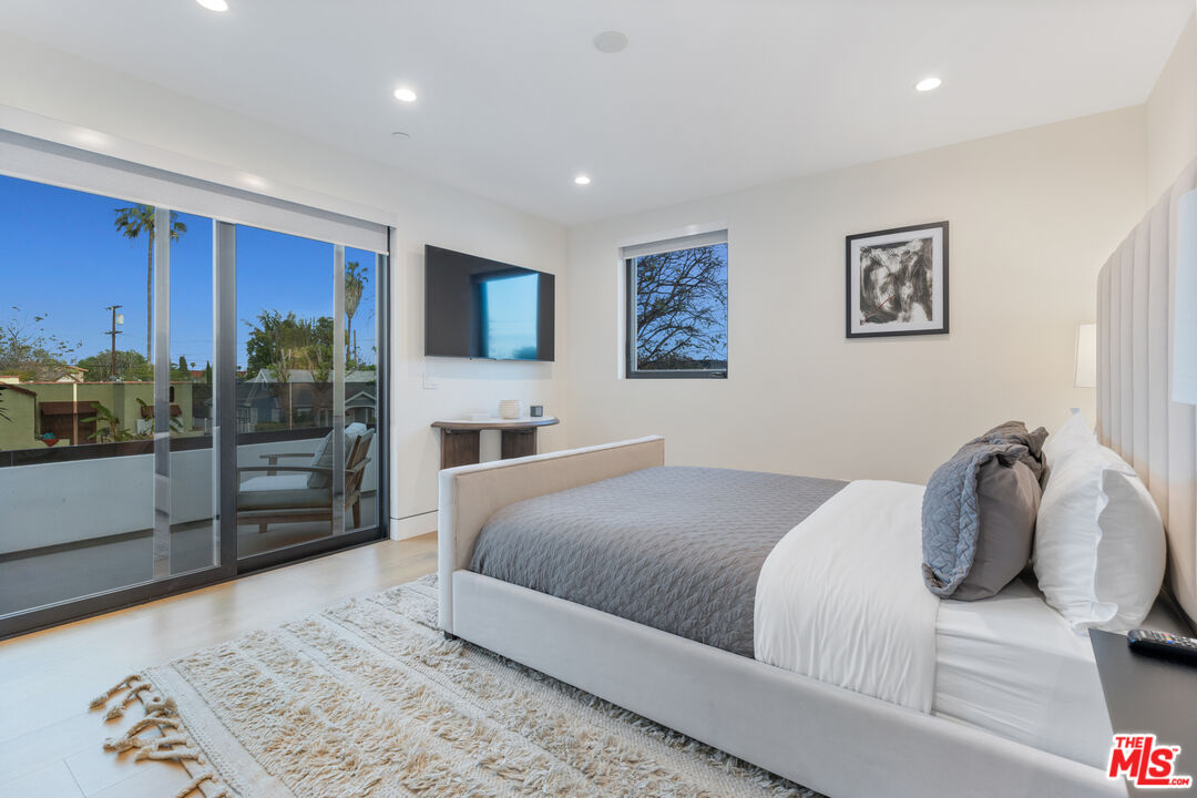 731 North Curson Avenue Los Angeles, CA 90046 - Photo 44 of 75 a bedroom with a large bed and a balcony