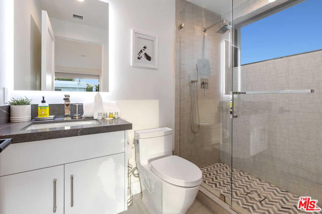 731 North Curson Avenue Los Angeles, CA 90046 - Photo 45 of 75 a bathroom with a sink toilet vanity and shower