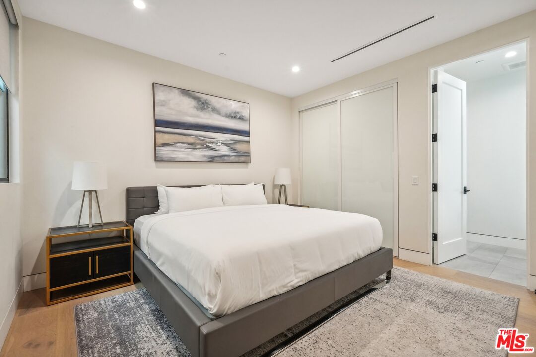 731 North Curson Avenue Los Angeles, CA 90046 - Photo 46 of 75 a bedroom with a bed and a refrigerator