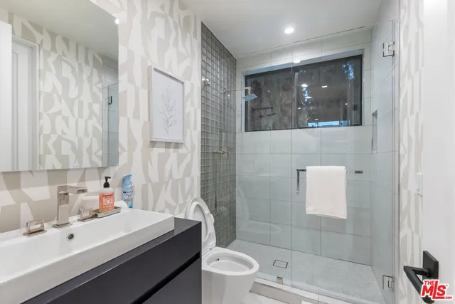 a living room with patio furniture and a potted plant