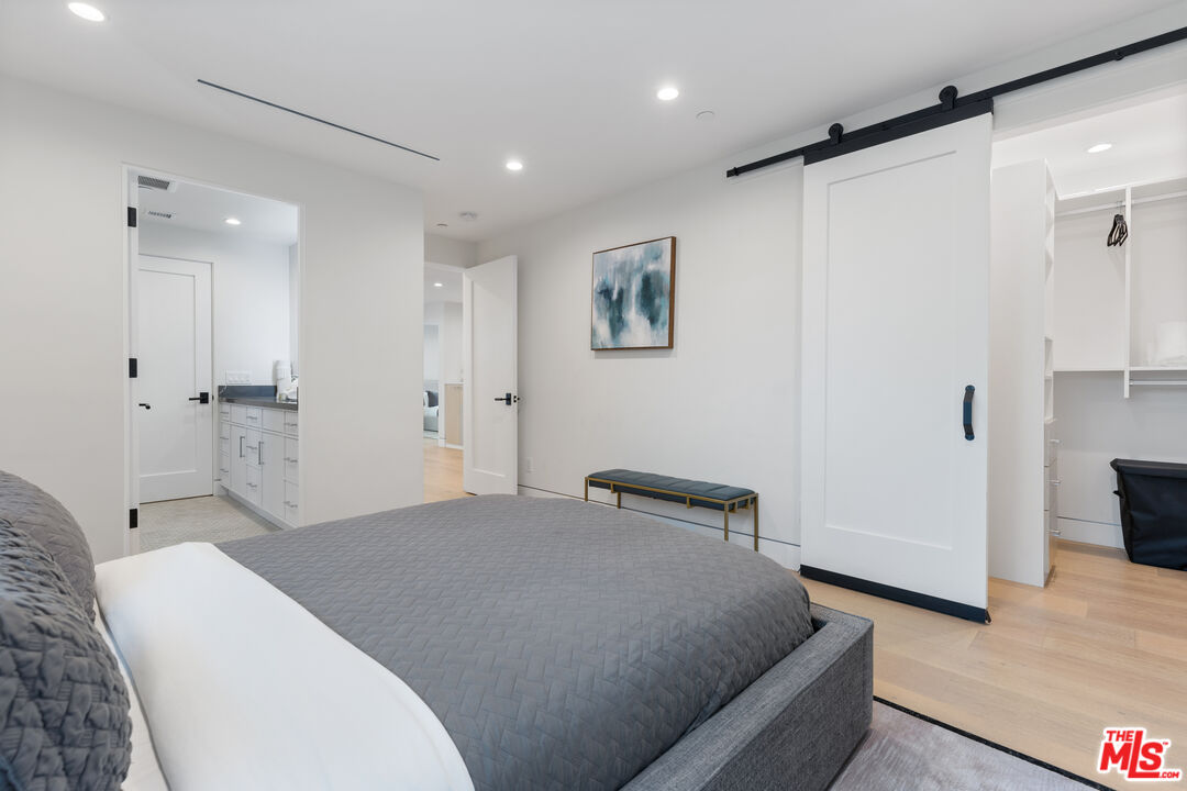 731 North Curson Avenue Los Angeles, CA 90046 - Photo 49 of 75 a bedroom with a bed and a refrigerator