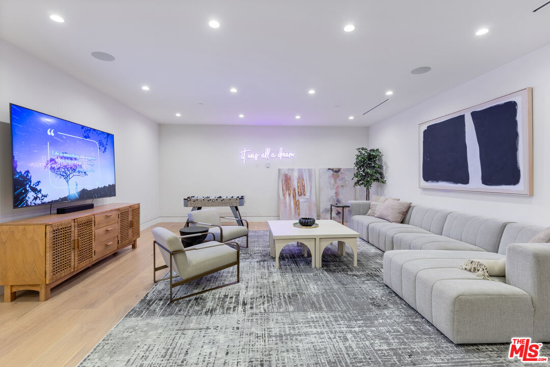 731 North Curson Avenue Los Angeles, CA 90046 - Photo 56 of 75 a living room with furniture and a flat screen tv