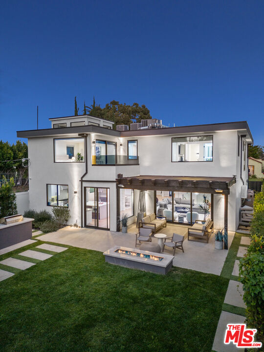 731 North Curson Avenue Los Angeles, CA 90046 - Photo 6 of 75 a front view of a house with a yard table and chairs