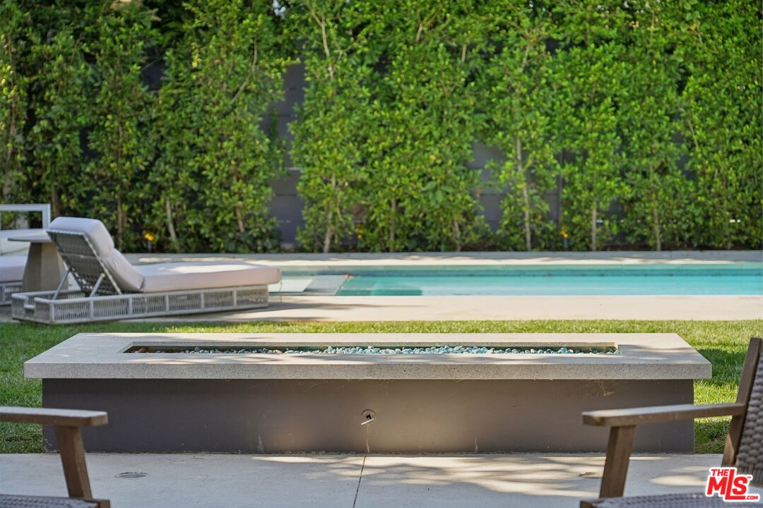 731 North Curson Avenue Los Angeles, CA 90046 - Photo 65 of 75 a view of a swimming pool with a lounge chair