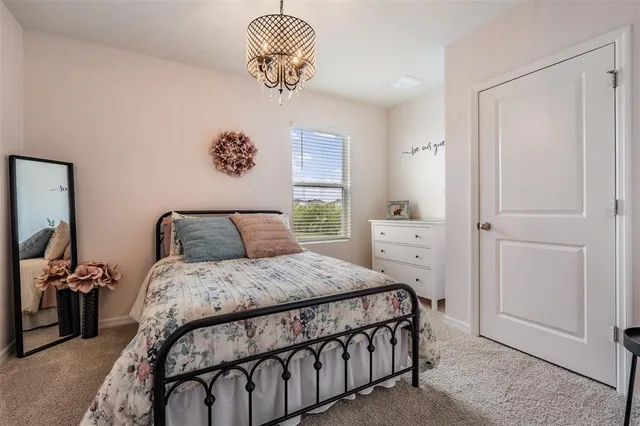 a bedroom with a bed and a chandelier