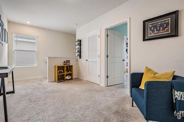 a view of an empty room with a fireplace and a window
