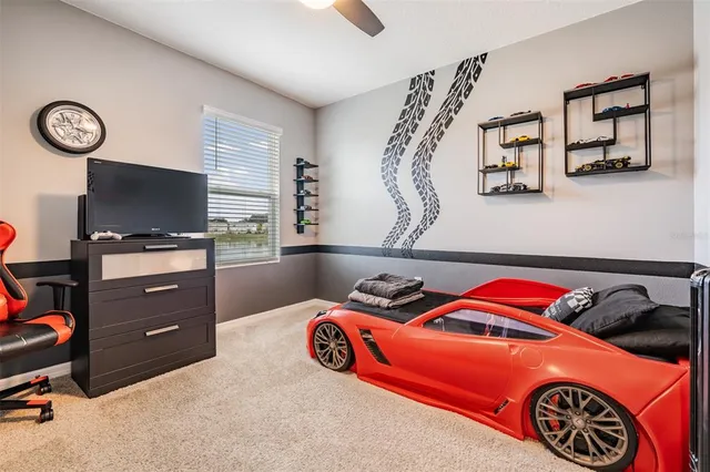 a bedroom with a bed and a tv in it