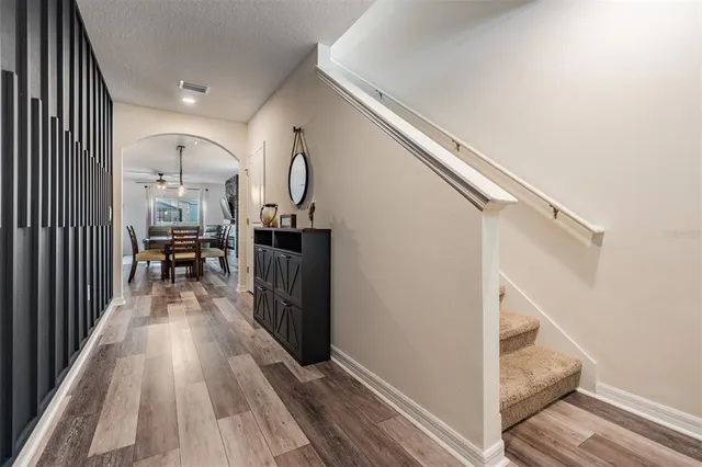 a view of a hallway view with wooden floor and staircase