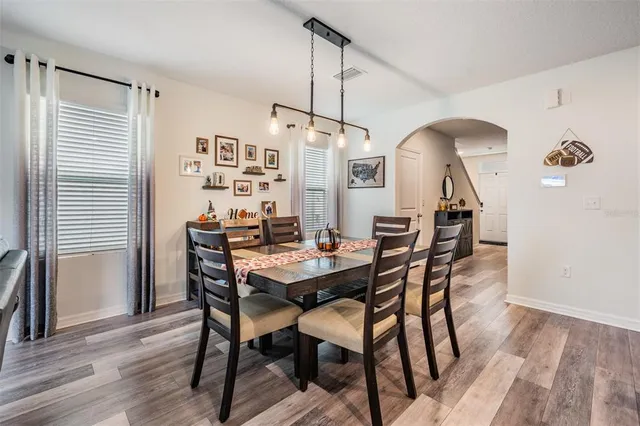 a view of a dining room with furniture and wooden floor