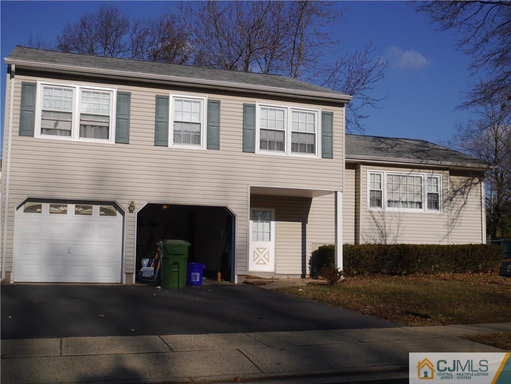 4 Meredith Road Edison, NJ 08817 - Photo 1 of 4 a front view of a house with a yard and garage