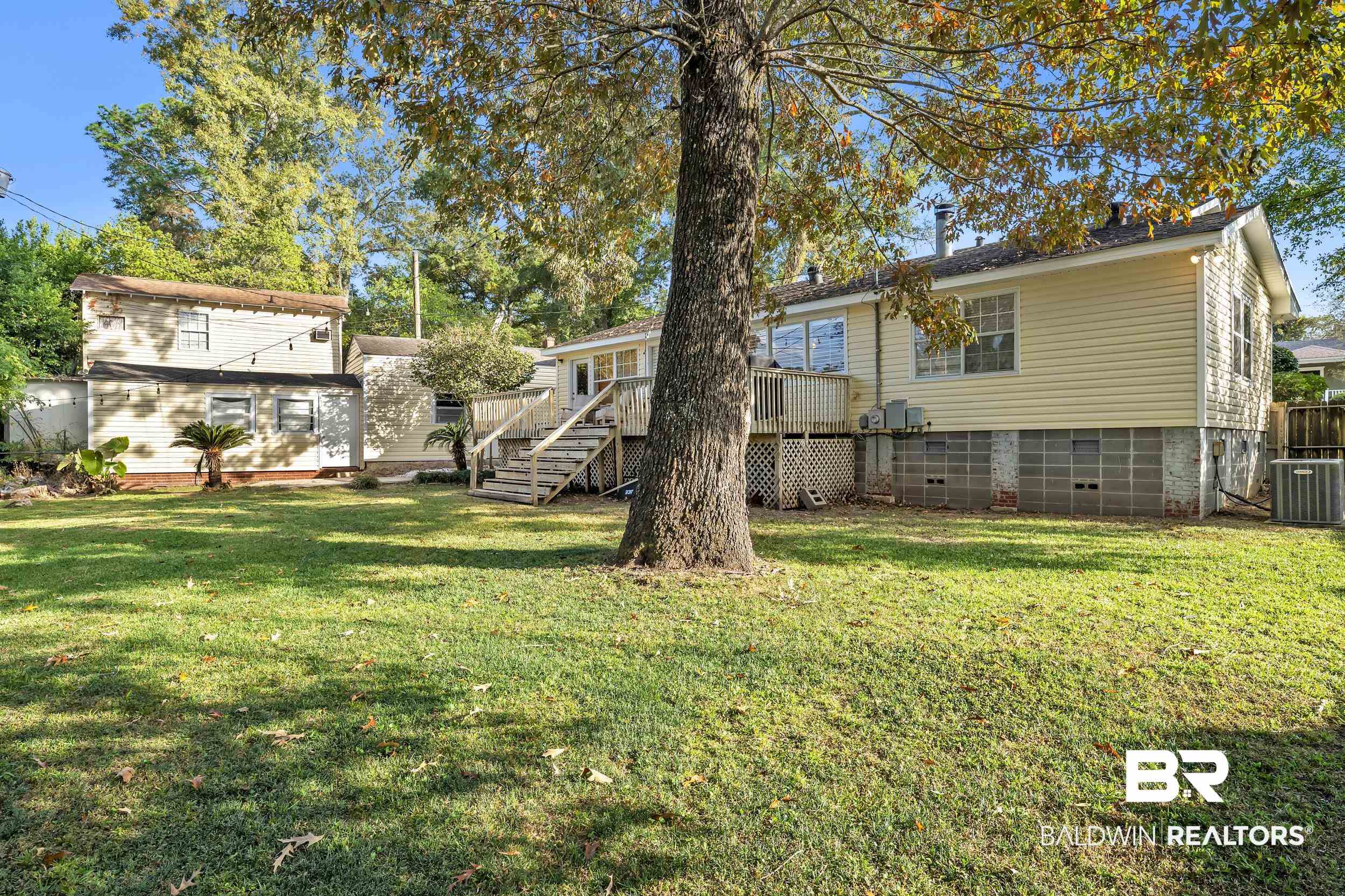18 York Place Mobile, AL 36608 - Photo 25 of 27 View of green lawn with stairs and a deck