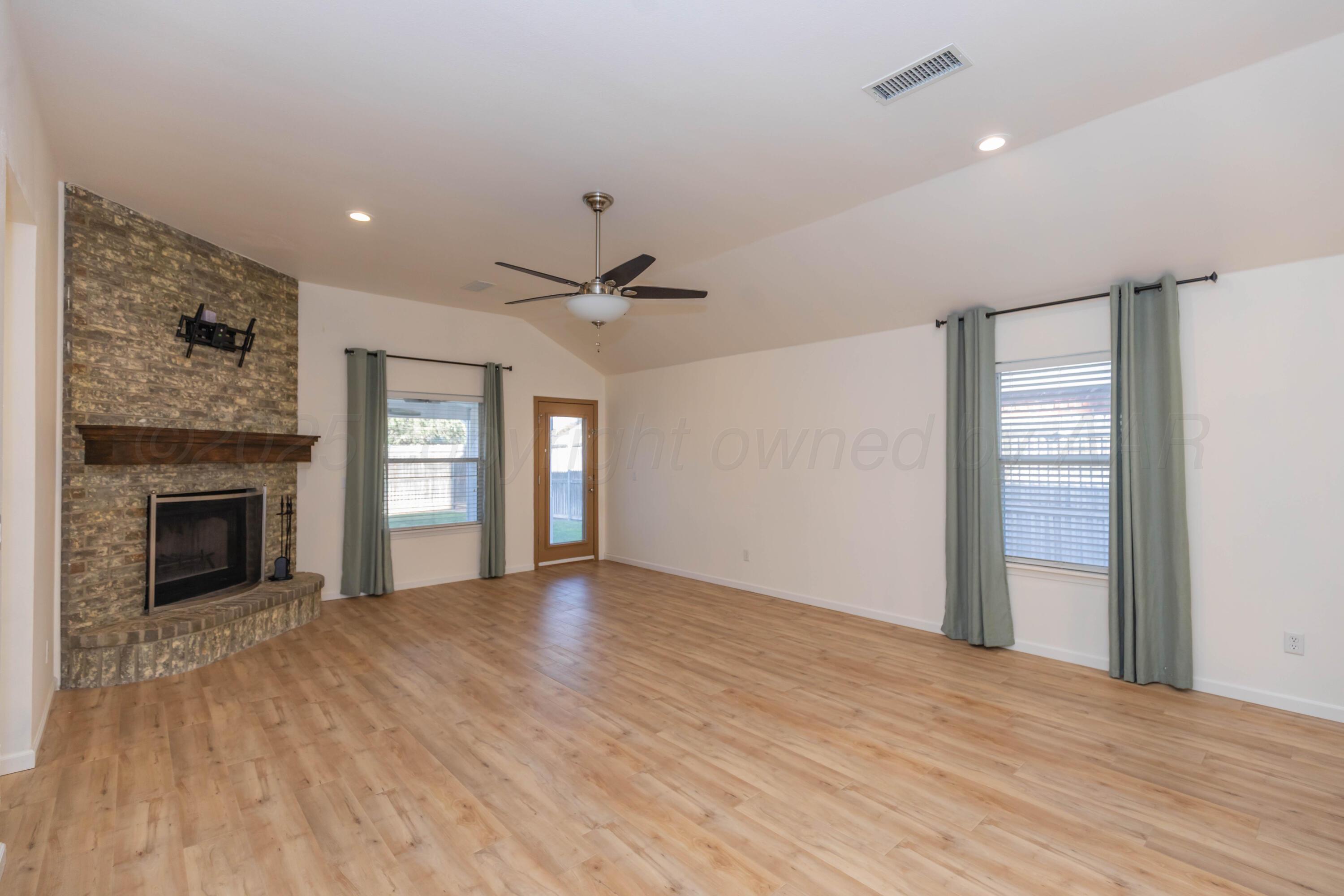 4810 Nimbus Lane Amarillo, TX 79110 - Photo 14 of 45 a view of an empty room with window and fire place