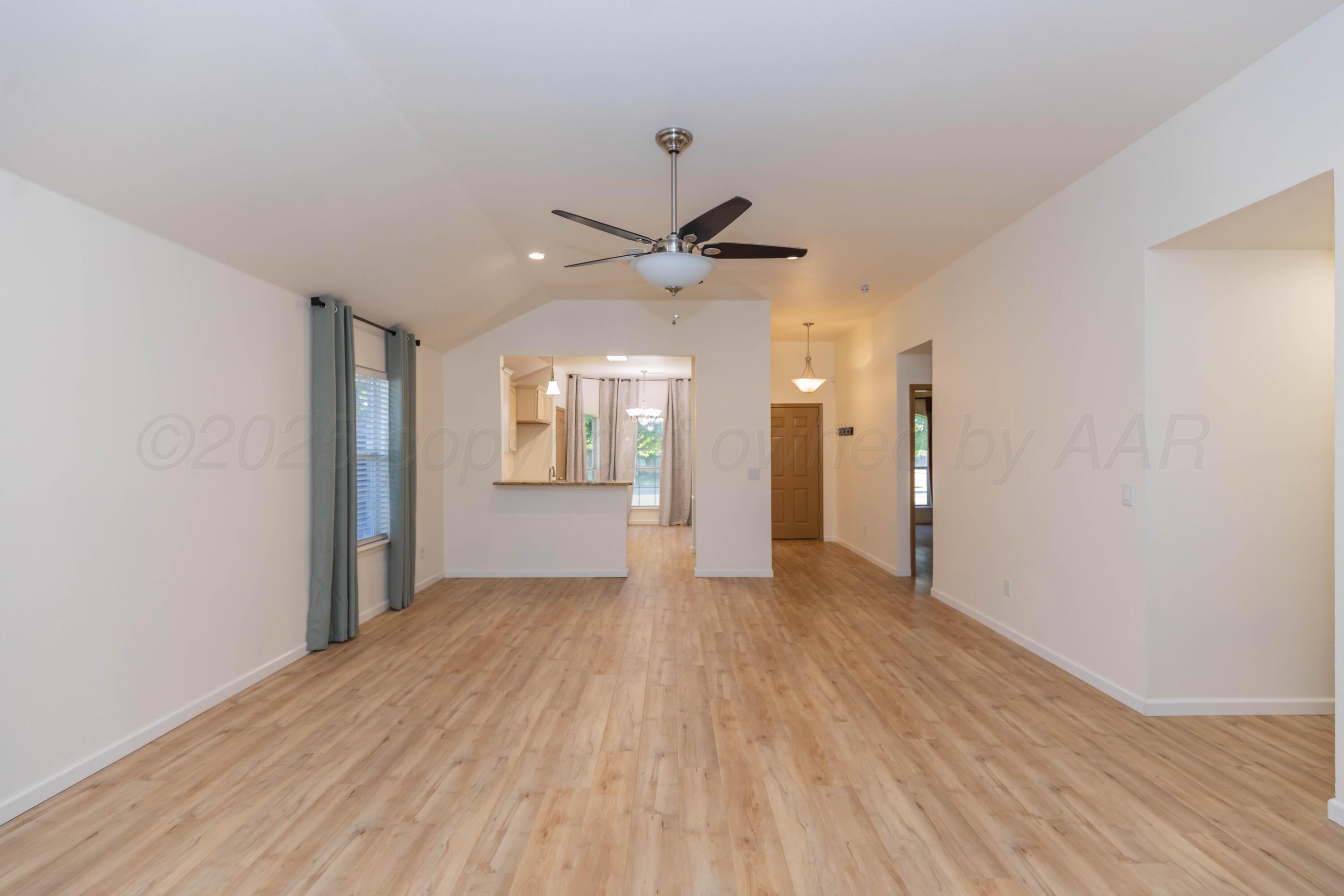 4810 Nimbus Lane Amarillo, TX 79110 - Photo 16 of 45 wooden floor in an empty room with a window