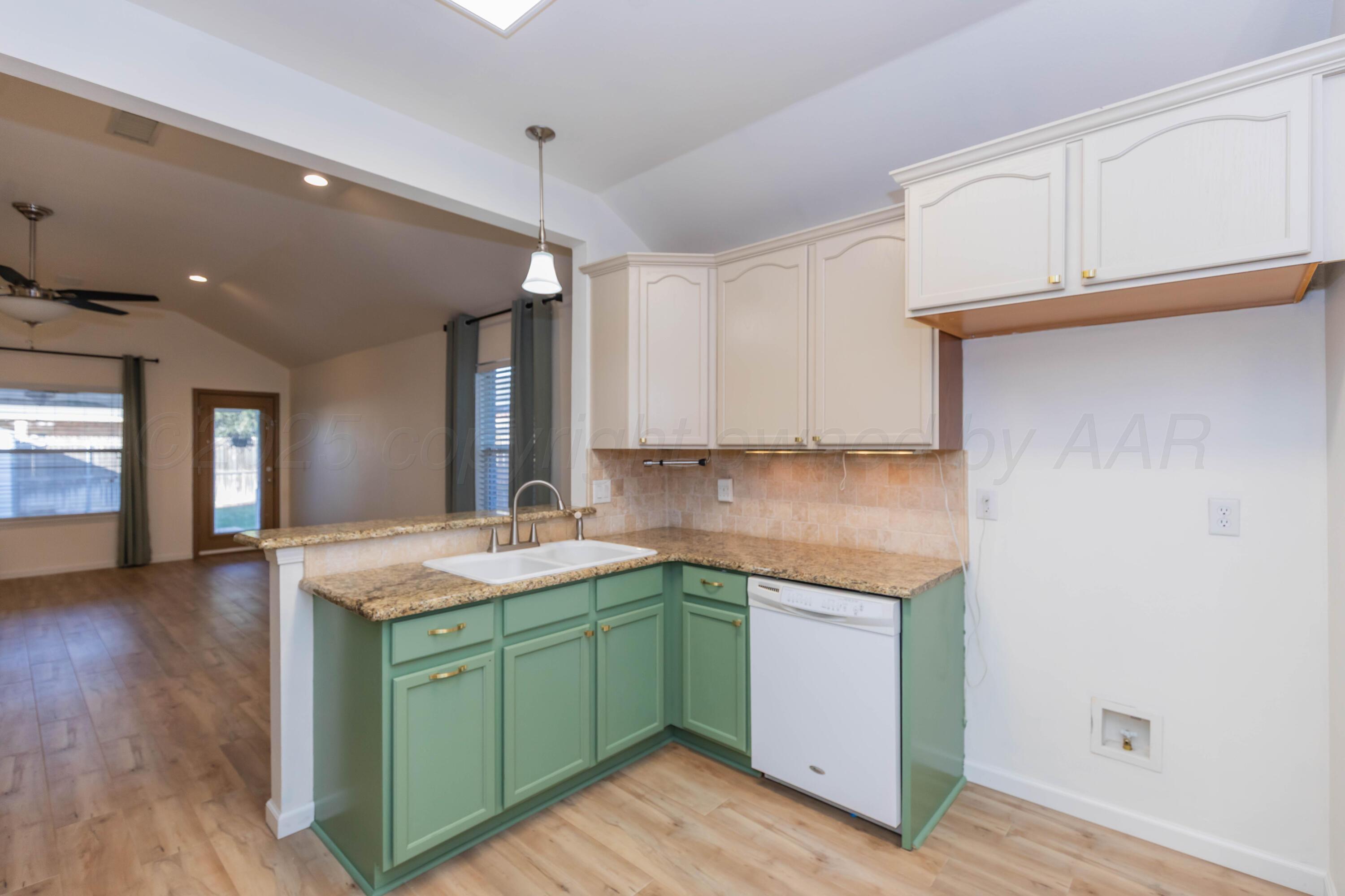 4810 Nimbus Lane Amarillo, TX 79110 - Photo 18 of 45 a kitchen with a sink cabinets and wooden floor