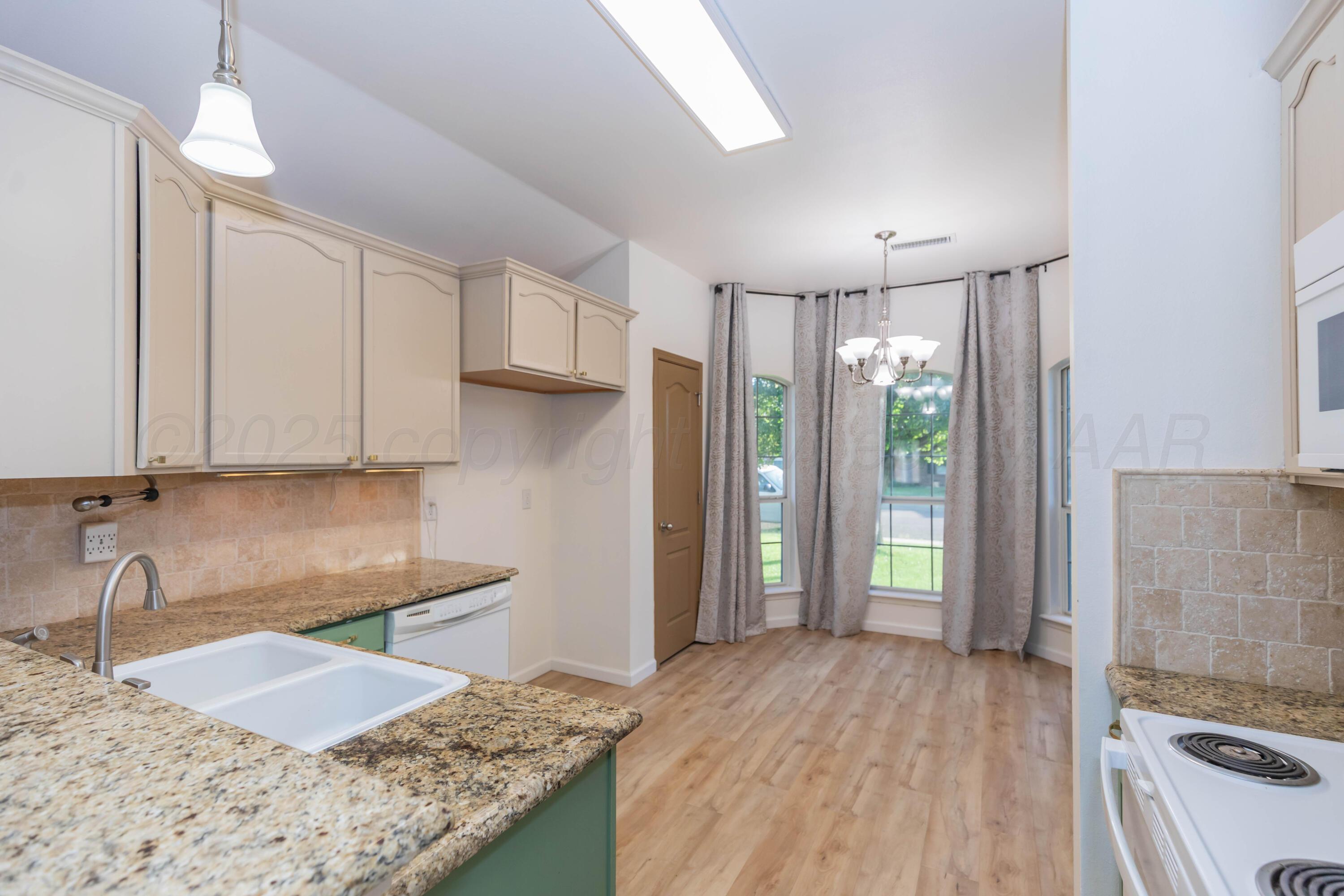 4810 Nimbus Lane Amarillo, TX 79110 - Photo 20 of 45 a kitchen with granite countertop a sink stove and refrigerator