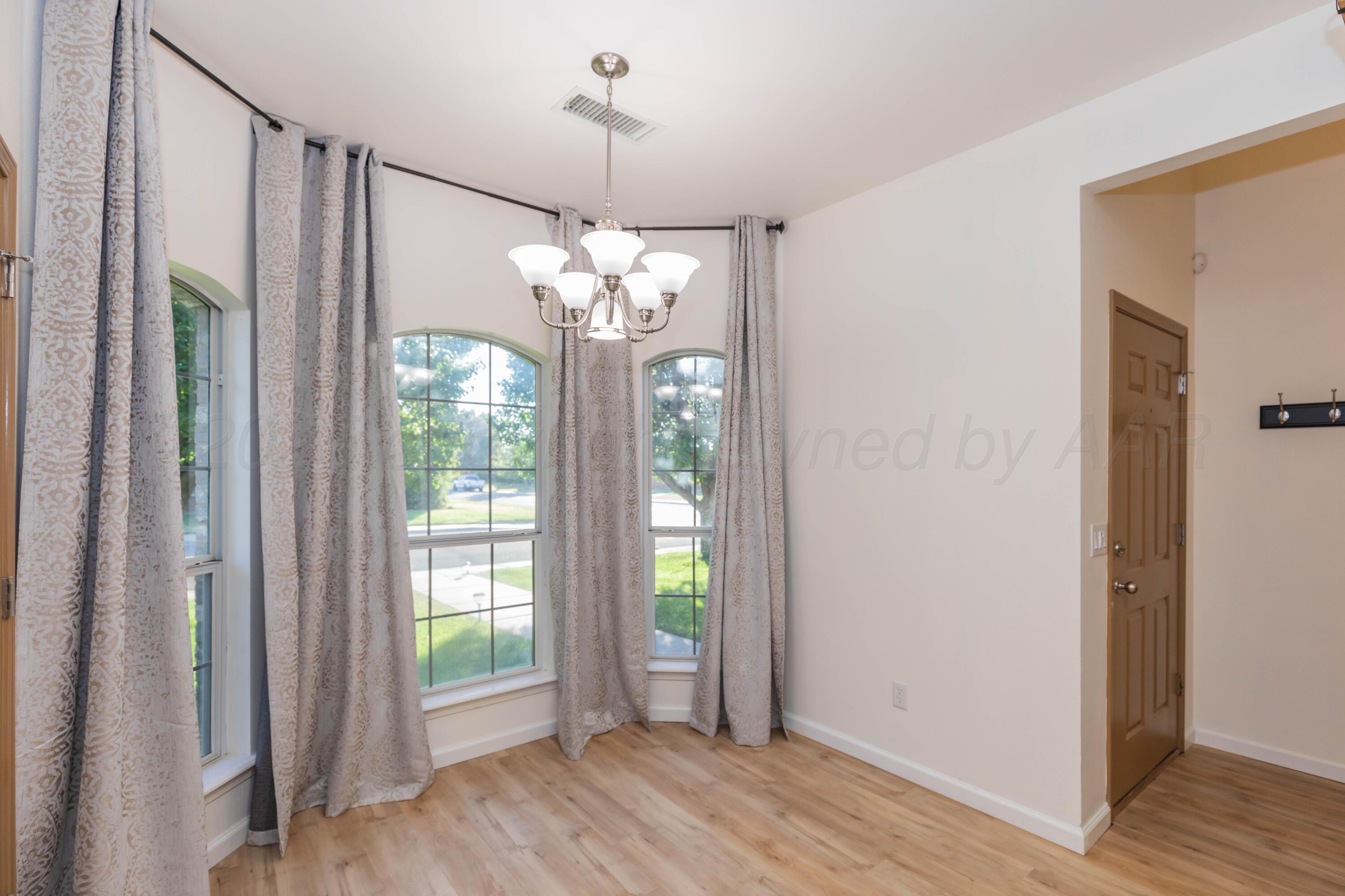 4810 Nimbus Lane Amarillo, TX 79110 - Photo 21 of 45 a view of a chandelier in hallway with wooden floor and chandelier