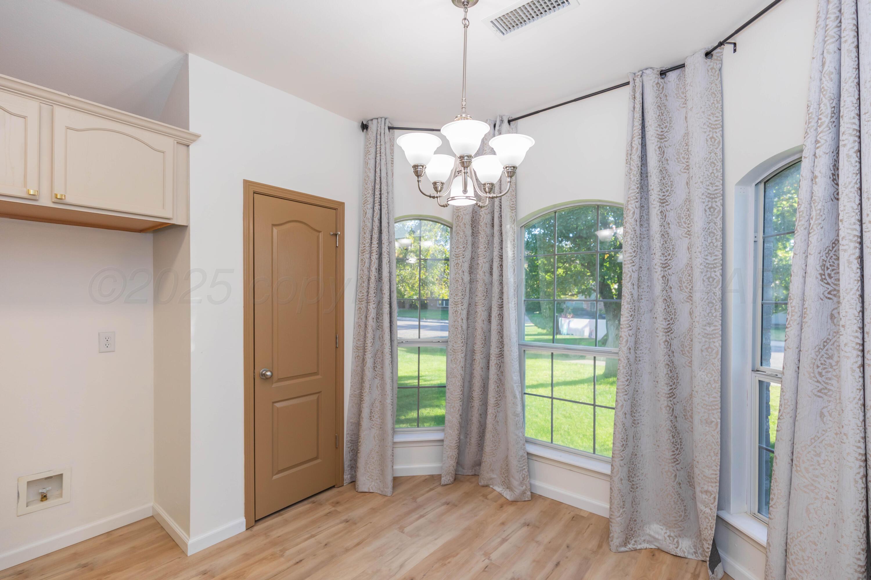 4810 Nimbus Lane Amarillo, TX 79110 - Photo 22 of 45 a view of a big room with wooden floor chandelier and livingroom