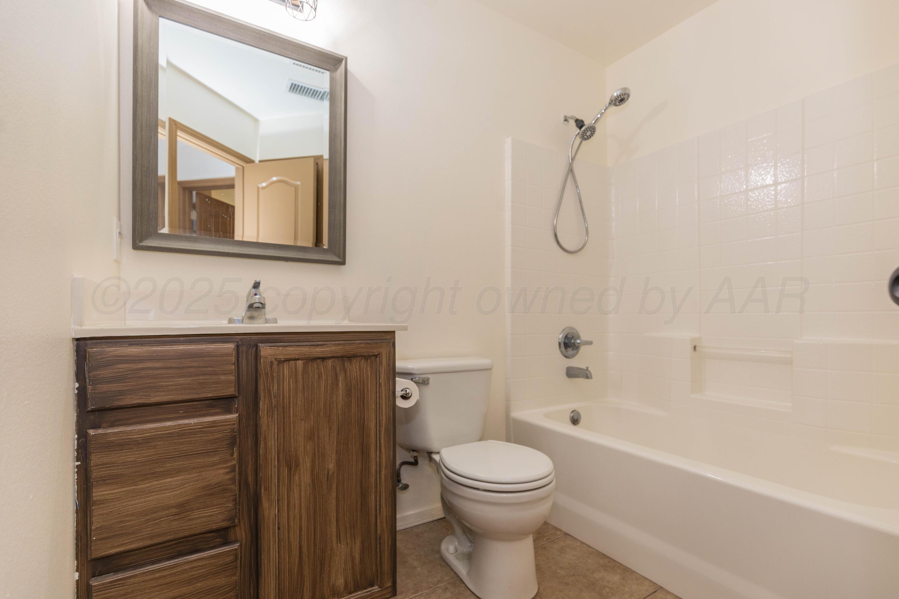 4810 Nimbus Lane Amarillo, TX 79110 - Photo 31 of 45 a bathroom with a toilet sink vanity tub and mirror
