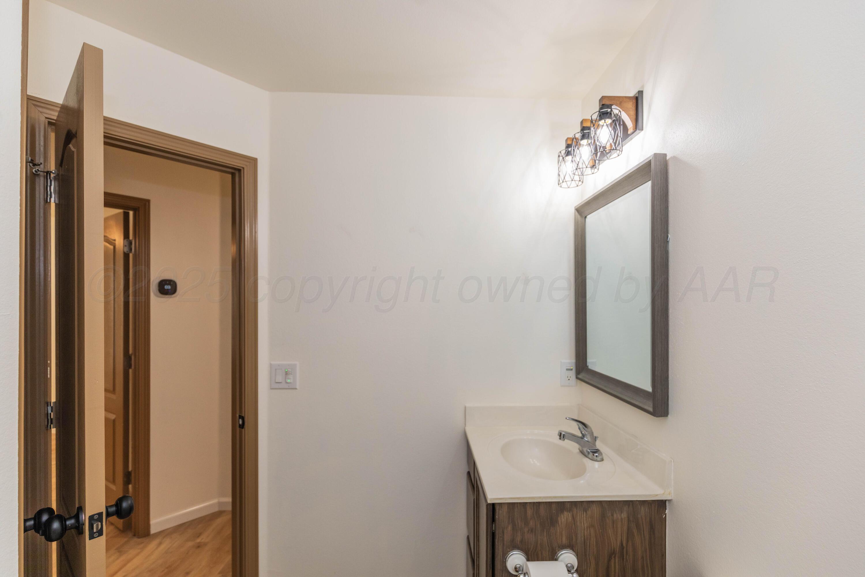 4810 Nimbus Lane Amarillo, TX 79110 - Photo 32 of 45 a bathroom with a sink a mirror and vanity