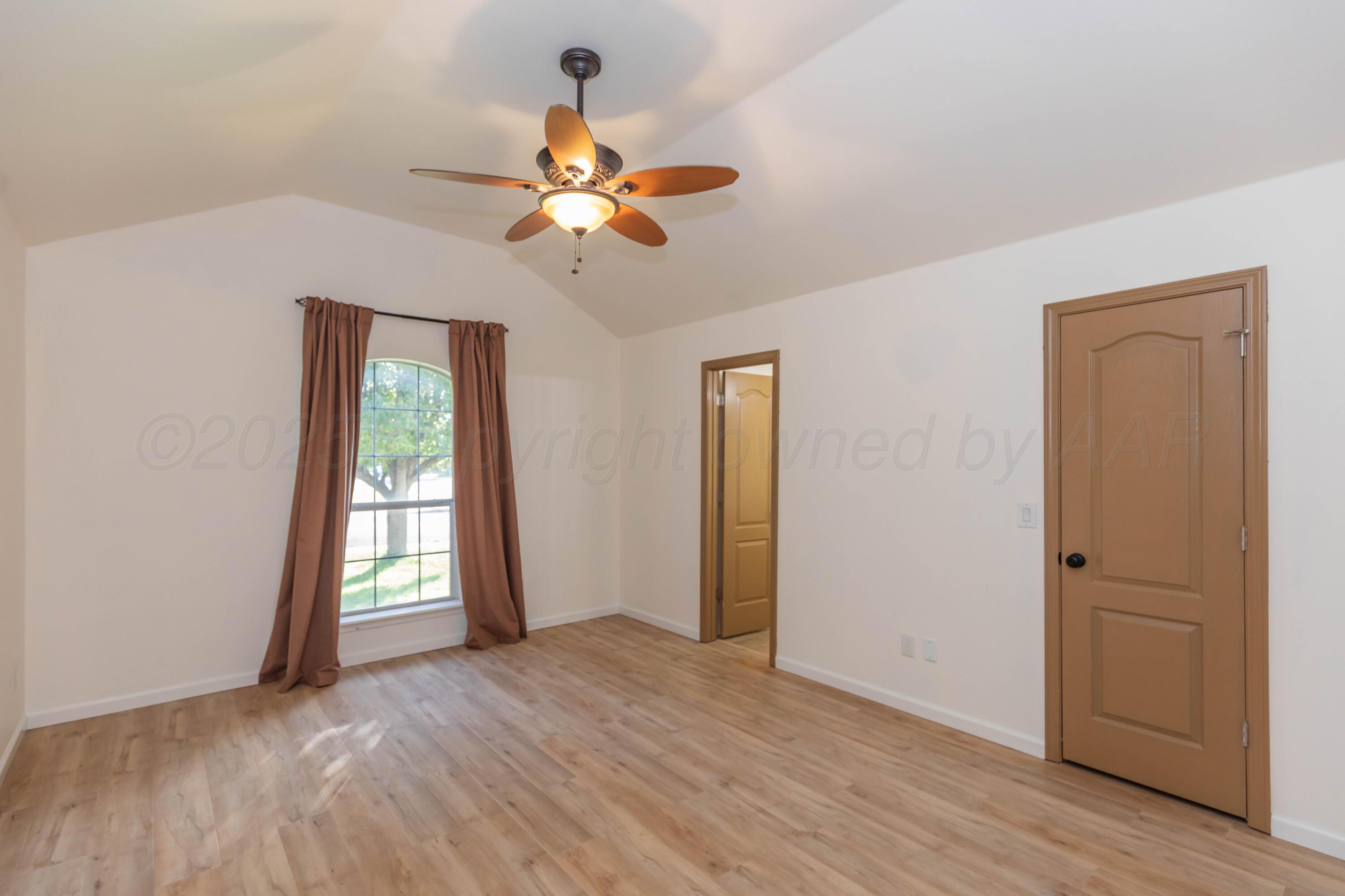 4810 Nimbus Lane Amarillo, TX 79110 - Photo 5 of 45 wooden floor in an empty room with a window