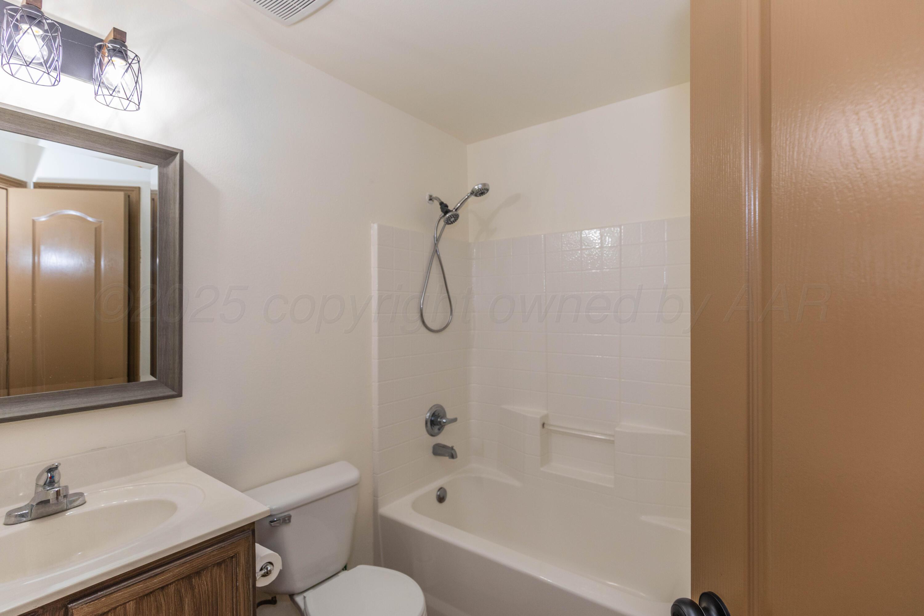 4810 Nimbus Lane Amarillo, TX 79110 - Photo 8 of 45 a bathroom with a sink mirror toilet and bathtub