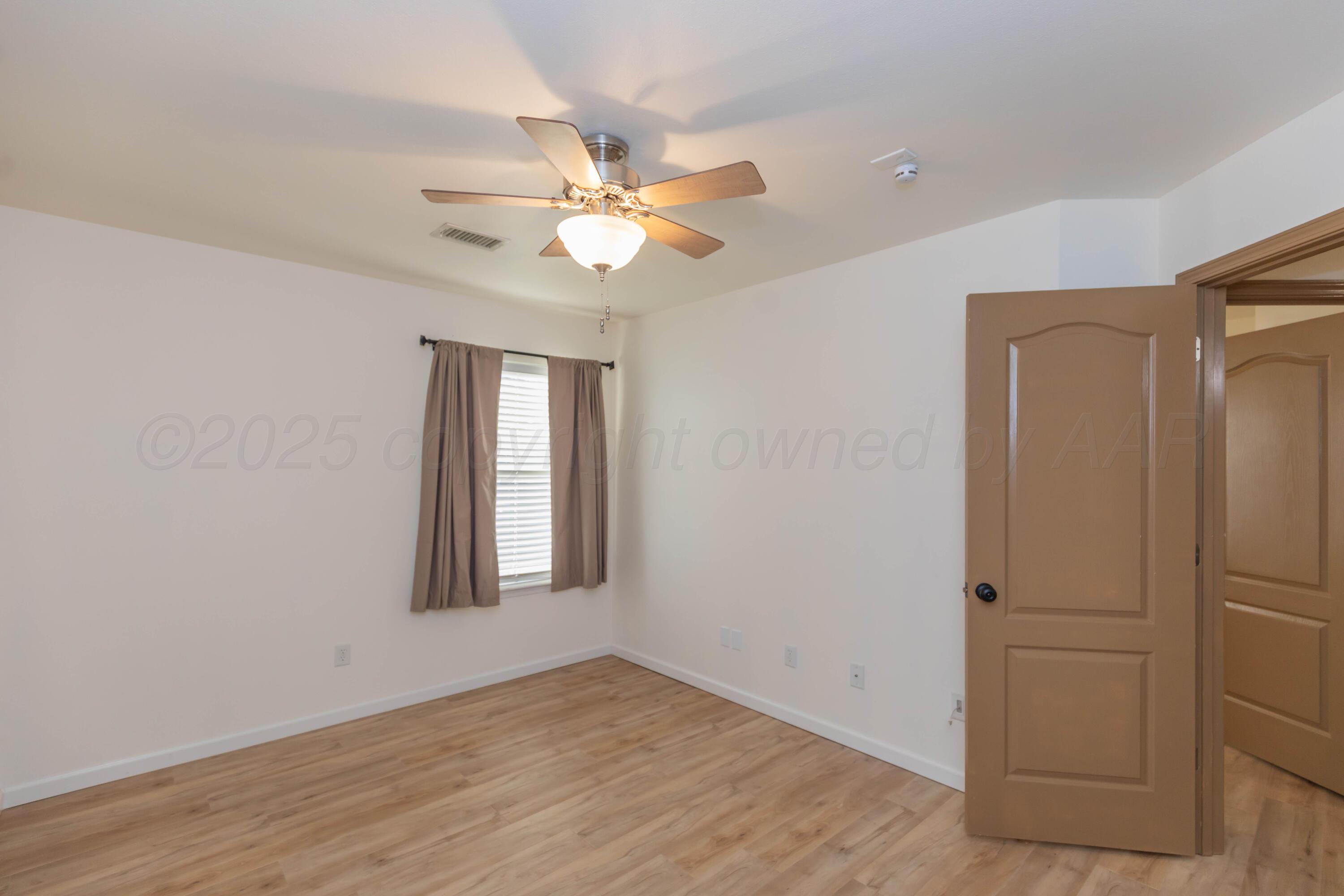 4810 Nimbus Lane Amarillo, TX 79110 - Photo 9 of 45 an empty room with windows and fan