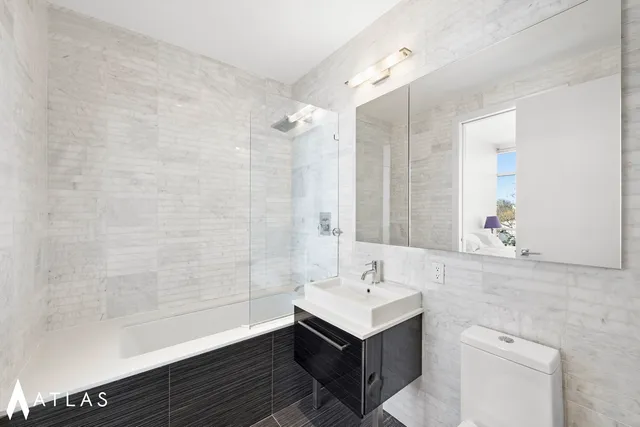 a kitchen with stainless steel appliances granite countertop a stove and a refrigerator