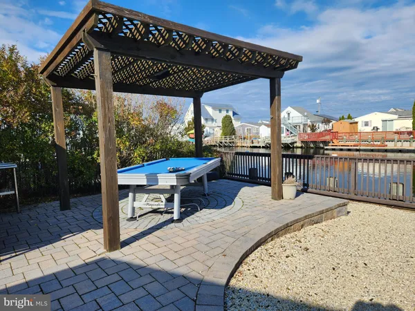 a view of a roof deck with wooden floor and fence