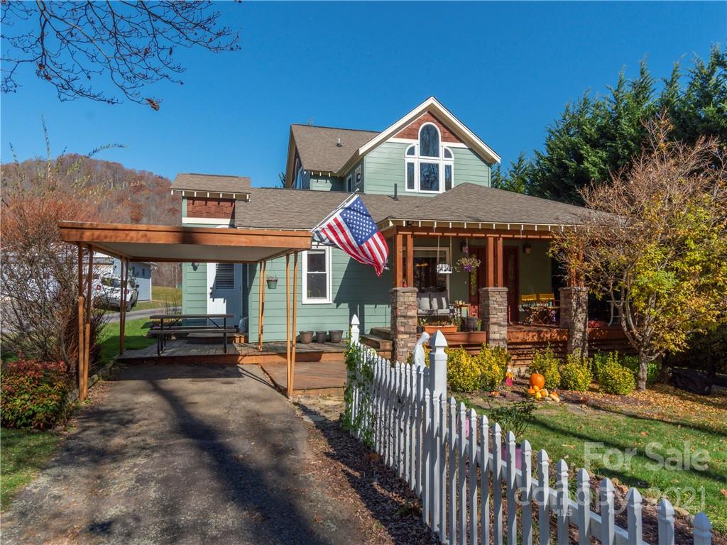 456 Walker Road Waynesville, NC 28786 - Photo 1 of 24 a view of a house with a porch and furniture