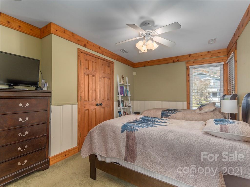 456 Walker Road Waynesville, NC 28786 - Photo 13 of 24 a bedroom with a bed and a flat screen tv