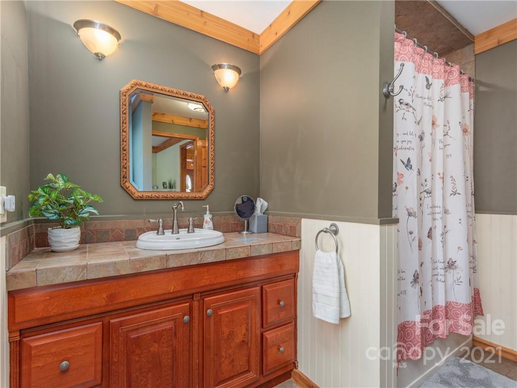 456 Walker Road Waynesville, NC 28786 - Photo 14 of 24 a bathroom with a sink vanity and a mirror