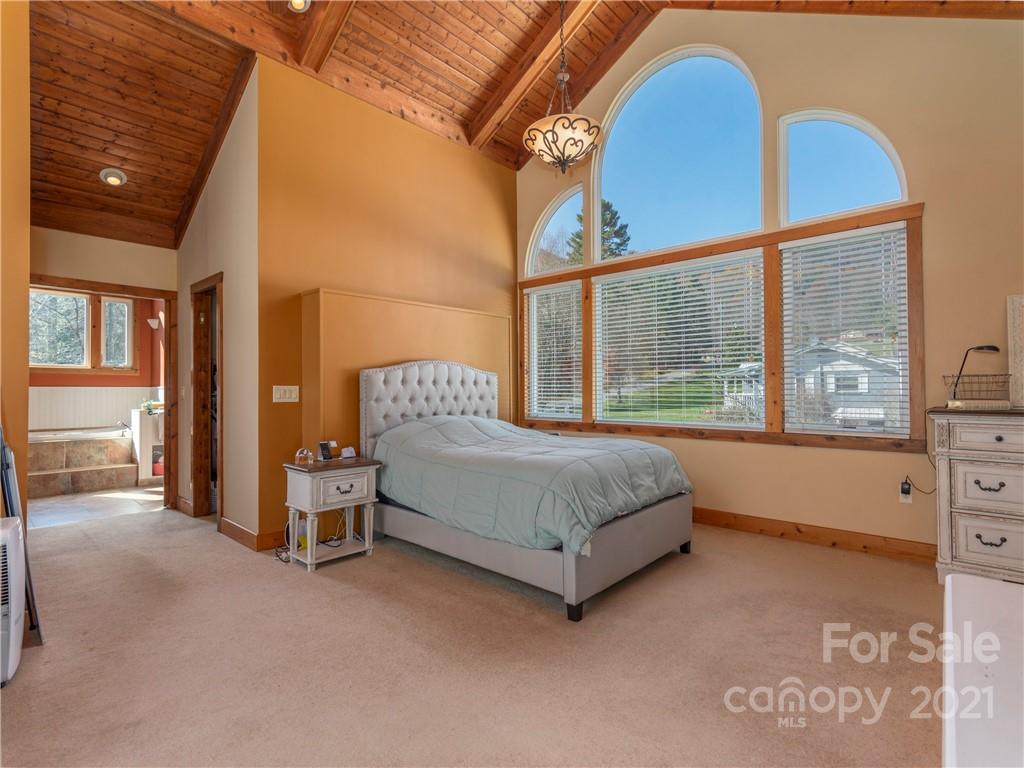 456 Walker Road Waynesville, NC 28786 - Photo 15 of 24 a bedroom with a bed and a large window