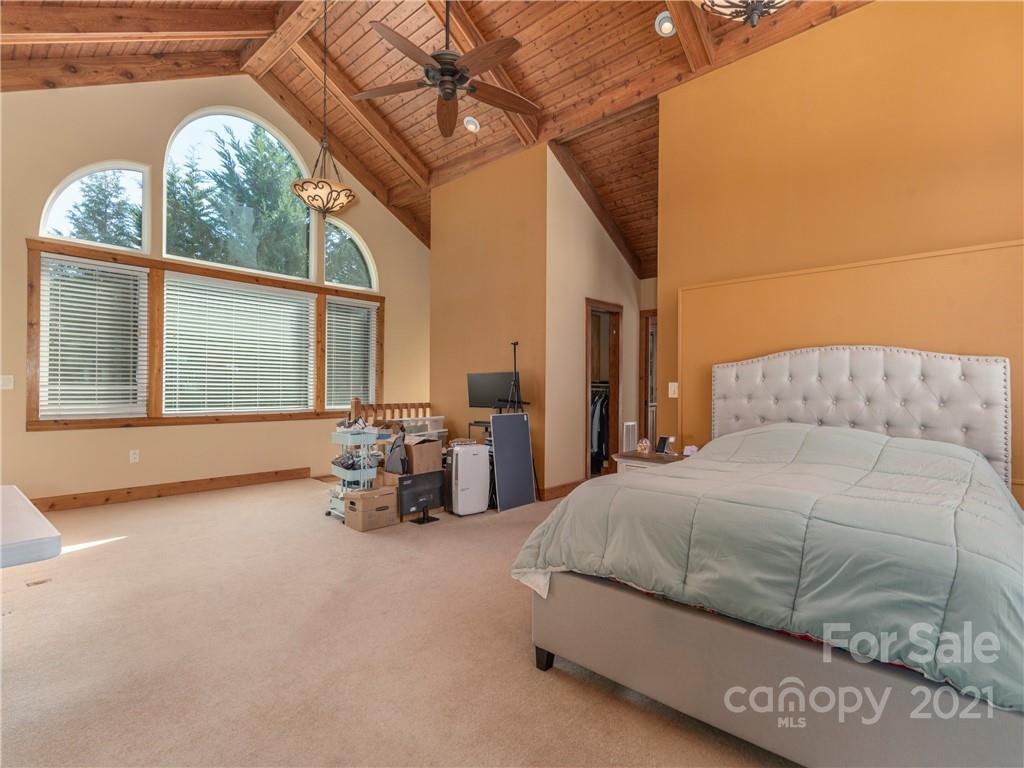 456 Walker Road Waynesville, NC 28786 - Photo 16 of 24 a bedroom with a bed and large windows