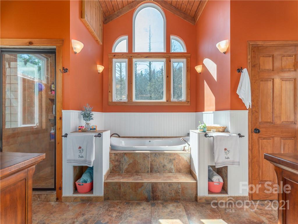 456 Walker Road Waynesville, NC 28786 - Photo 18 of 24 a bathroom with a tub and shower