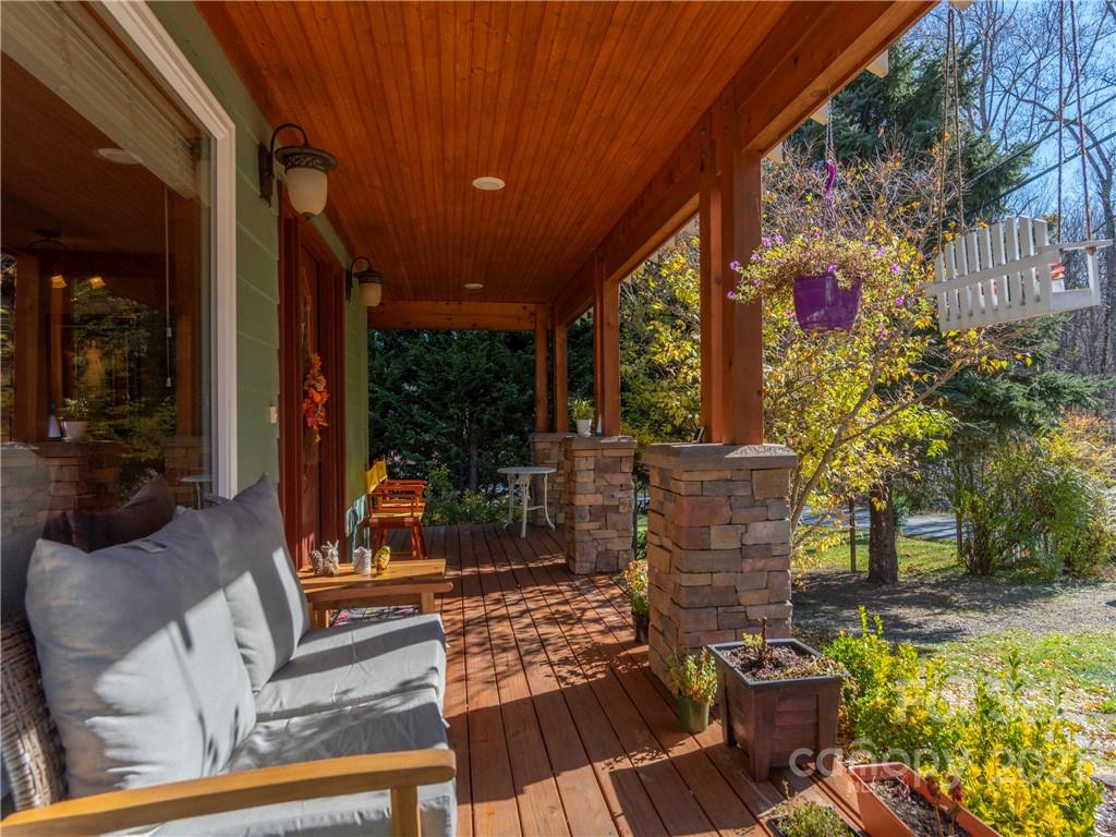 456 Walker Road Waynesville, NC 28786 - Photo 3 of 24 a view of a patio with table and chairs potted plants and floor to ceiling window