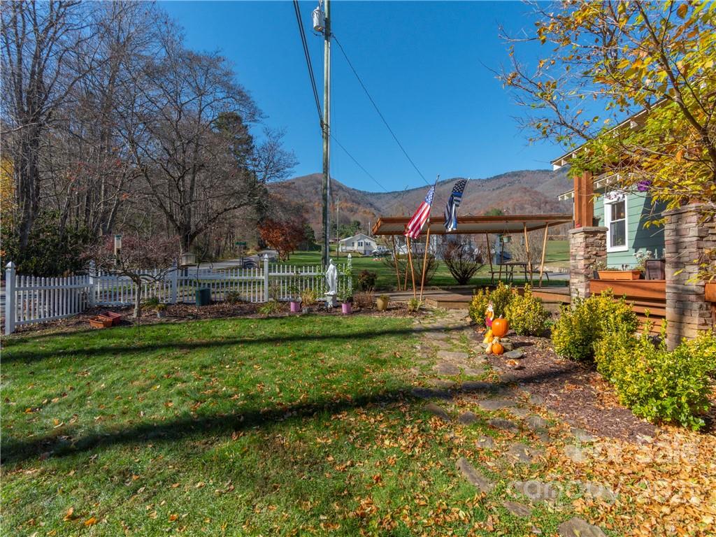456 Walker Road Waynesville, NC 28786 - Photo 22 of 24 a view of a park with large trees and a wooden fence