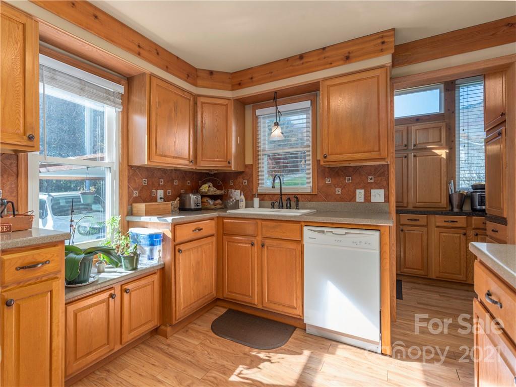 456 Walker Road Waynesville, NC 28786 - Photo 6 of 24 a kitchen with stainless steel appliances granite countertop a stove a sink and a refrigerator