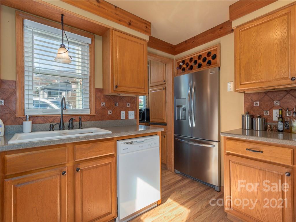 456 Walker Road Waynesville, NC 28786 - Photo 7 of 24 a kitchen with stainless steel appliances granite countertop a refrigerator and a sink