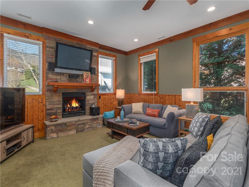 456 Walker Road Waynesville, NC 28786 - Photo 10 of 24 a living room with furniture a large window and a fireplace