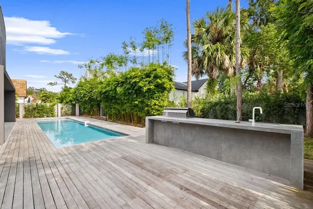an aerial view of residential houses with outdoor space and ocean view