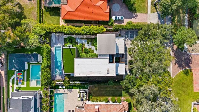 an aerial view of a house with garden space and street view