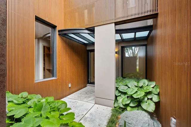 a large white kitchen with granite countertop a sink and dishwasher a stove top oven with wooden floor