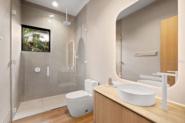 a bedroom with a bed and a view of kitchen